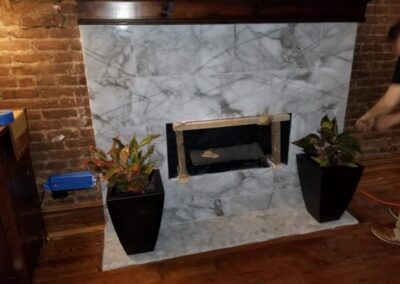 A fireplace in a room with a brick wall