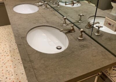 A bathroom with two sinks and a mirror