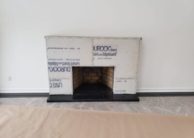 A white box sitting on top of a wooden fire place