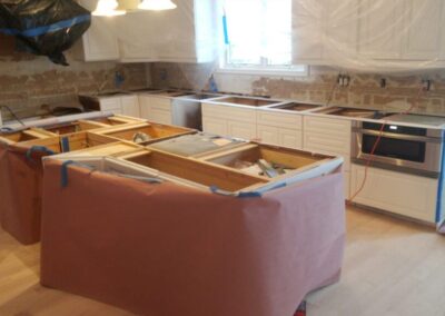 A kitchen is being remodeled with a pink cover