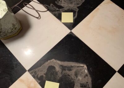 A black and white checkered floor with post it notes on it