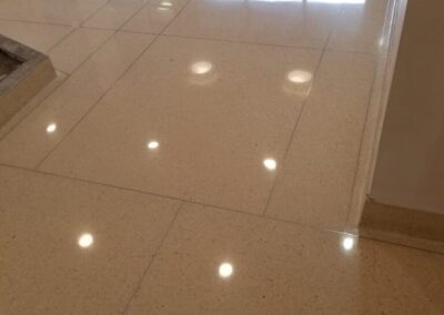 A hallway with a tile floor and white walls