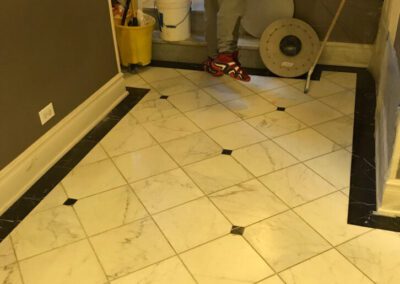 A man standing in a bathroom next to a toilet