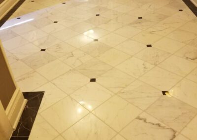 A white marble floor with black and white tiles