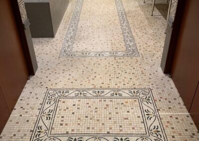 A bathroom with a tiled floor and walls