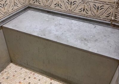 A bathroom with a tiled floor and walls