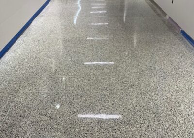 A long hallway with white walls and blue trim