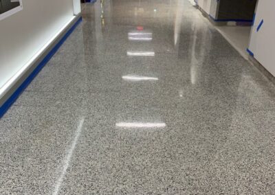 A long hallway with shadow of lights and blue lines on the floor